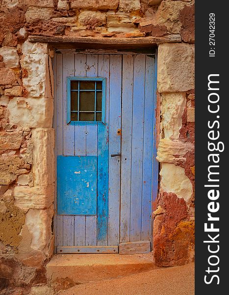 Old textured door in a stone wall