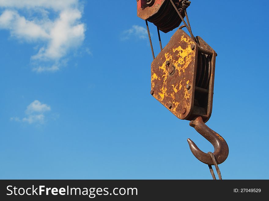 Hook crane on a background of blue sky. Hook crane on a background of blue sky