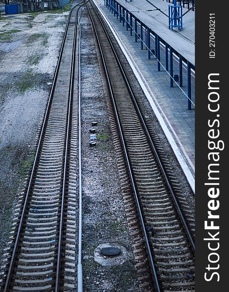 Empty Railway Station Platform. Blue Columns At The Train Station. Top View Of The Railway.