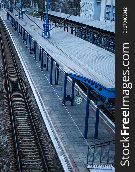 Empty Railway Station Platform. Blue Columns At The Train Station. Top View Of The Railway.