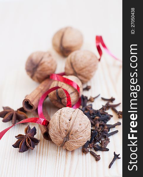 Cinnamon sticks, anise, walnut and cloves on a wooden table. Cinnamon sticks, anise, walnut and cloves on a wooden table