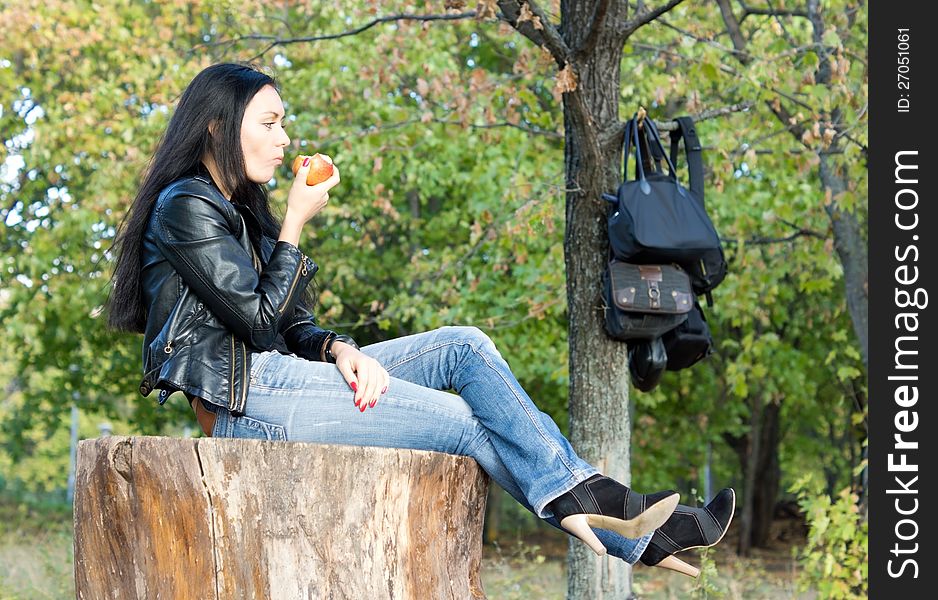 Woman Sitting Enjoying An Apple