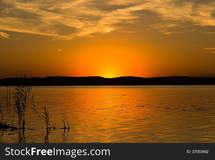 Sunset with reeds and cloud veil at Lake Balaton. Sunset with reeds and cloud veil at Lake Balaton