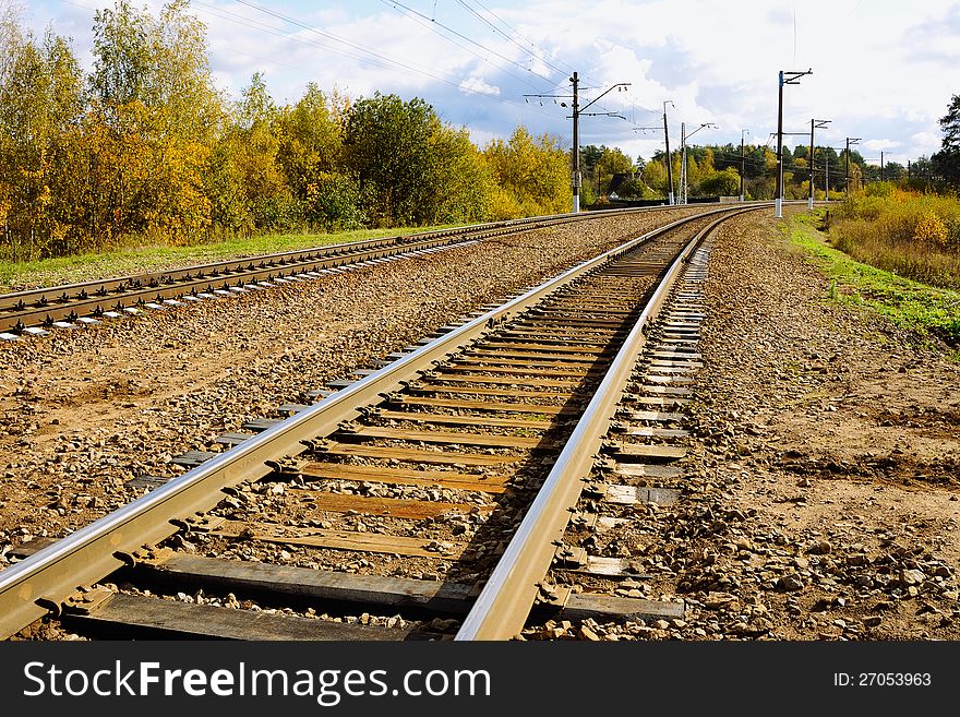 Railroad track among autumn trees