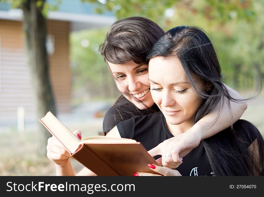 Women Laughing At A Book