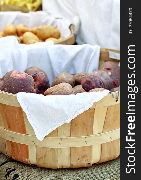 Large basket of potatoes at farmers market.