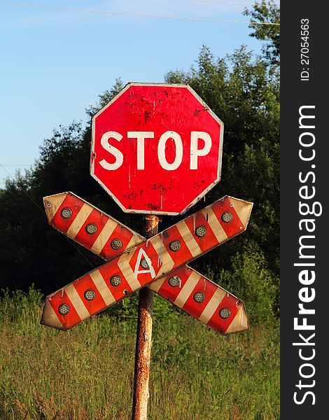 Stop sign on the railway crossroad