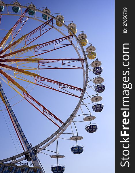 Ferris wheel on funfair with blue sky