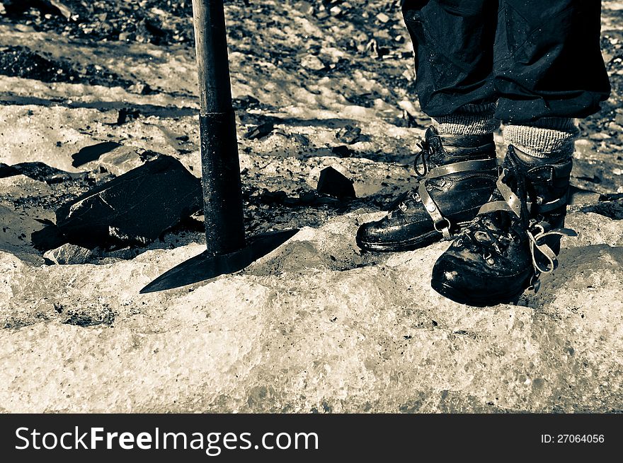 An explorer starting his adventure in Fox Glacier, New Zealand. Equipped well with glacier hiking tools and safety shoes. An explorer starting his adventure in Fox Glacier, New Zealand. Equipped well with glacier hiking tools and safety shoes