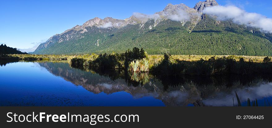 Panorama view of Mirror Lake in New Zealand. The mountains were reflected in the lake like a mirror reflection