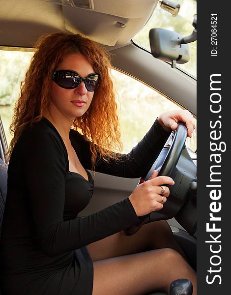 Red-haired woman driving car