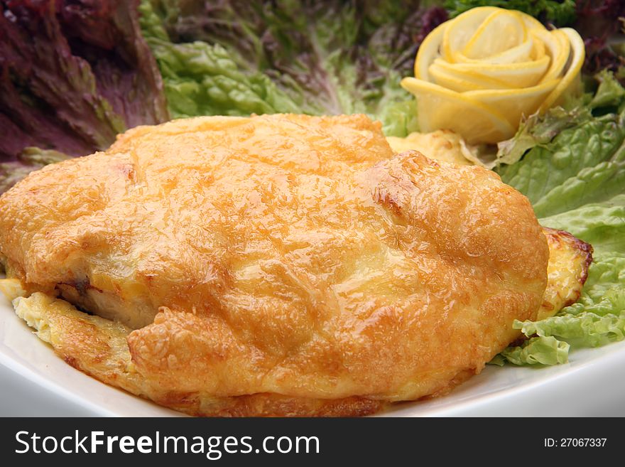 Meat in golden batter with lemon on salad leaf. Meat in golden batter with lemon on salad leaf