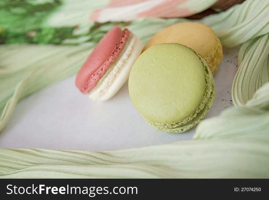 Close up soft green color macaron on colorful background. Close up soft green color macaron on colorful background