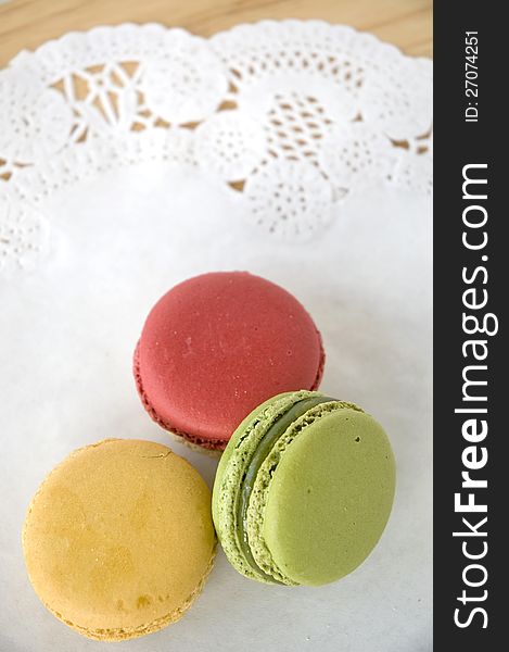 Three colorful macarons on white background