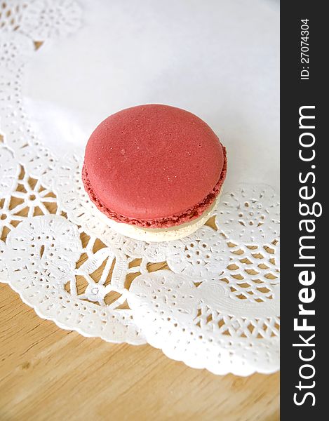 Red macaron on white curve texture. Red macaron on white curve texture