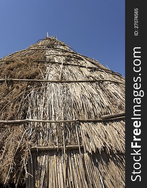 Roof of a traditional straw hut in greek country, on a sunny day