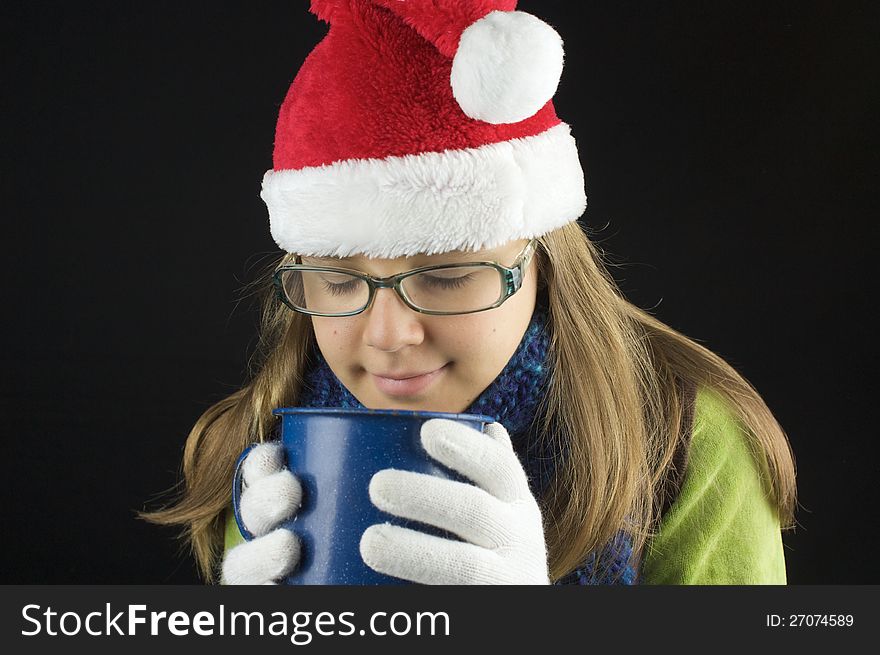 Young Girl Wearing Winter Clothing Holding Cup