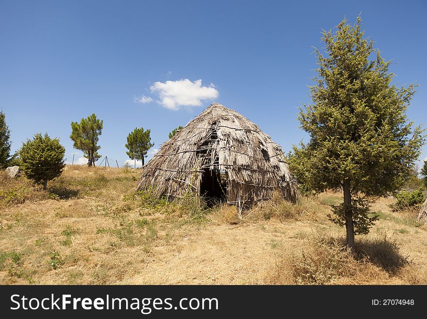 Traditional straw hut in greek country, on a sunny day