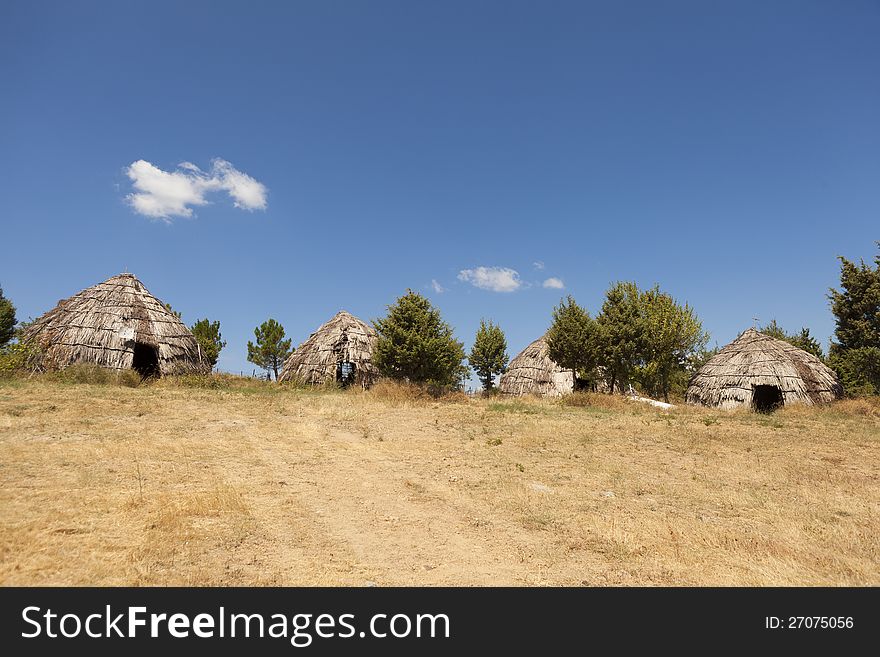 Traditional straw huts in greek country, on a sunny day