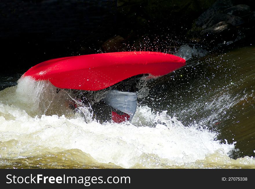 Sportsmen/women compete doing tricks in waves with kayaks. Sportsmen/women compete doing tricks in waves with kayaks.