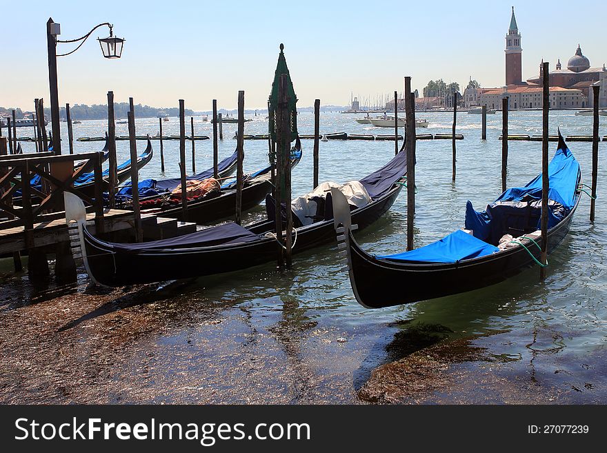Several moored gondolas in Venice. Sky is clear. Several moored gondolas in Venice. Sky is clear.