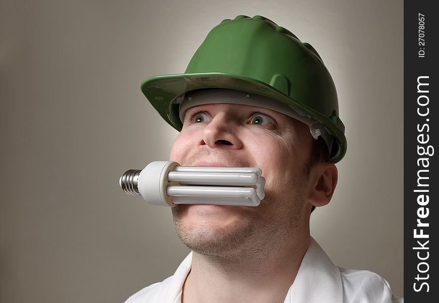 Environmental engineer with a lightbulb in his mouth. Environmental engineer with a lightbulb in his mouth
