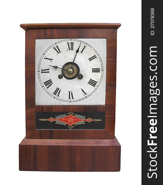 Antique table clock in a plain natural wooden case with decoration. Isolated on white. Antique table clock in a plain natural wooden case with decoration. Isolated on white.