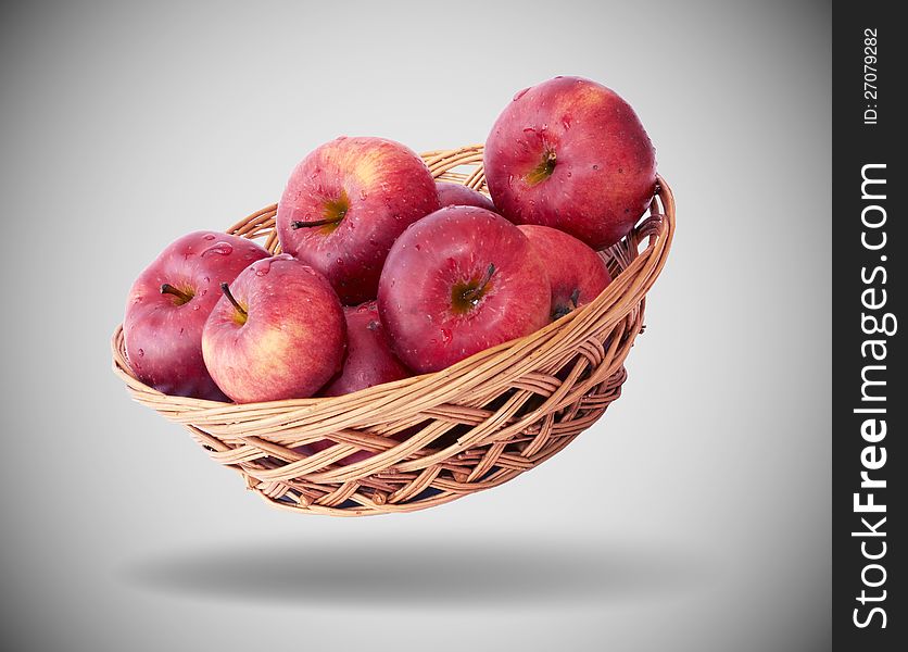 Apples in a basket on gray background. Apples in a basket on gray background