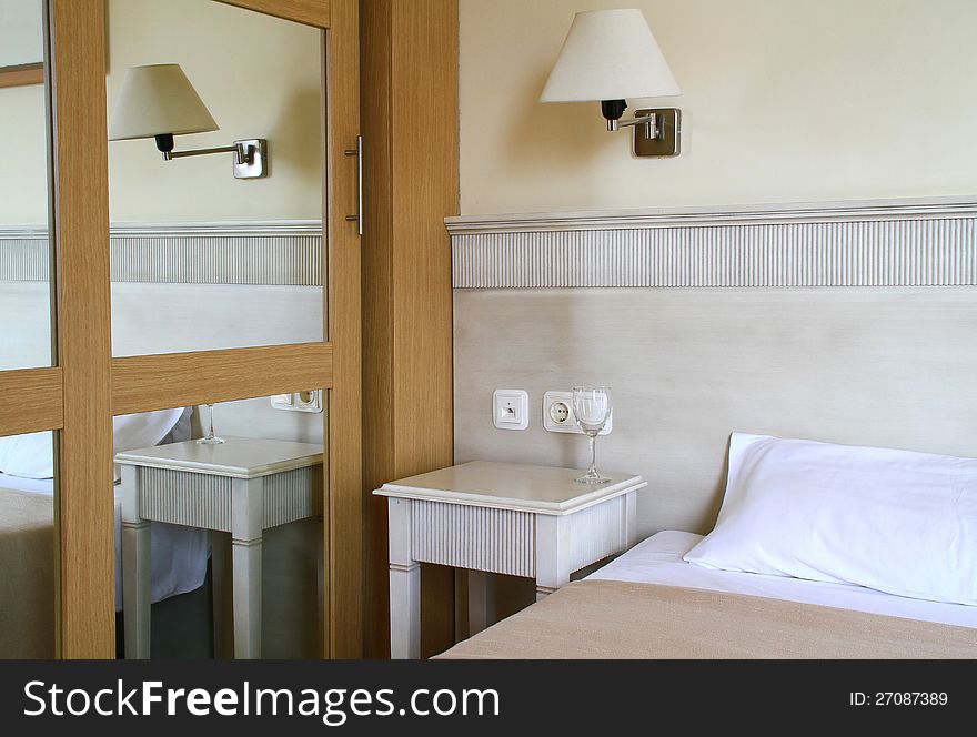 Image of a bedroom with glass on table. Image of a bedroom with glass on table