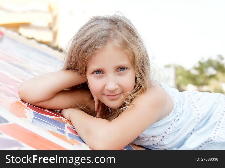 Portrait of a cute baby girl blonde on outside