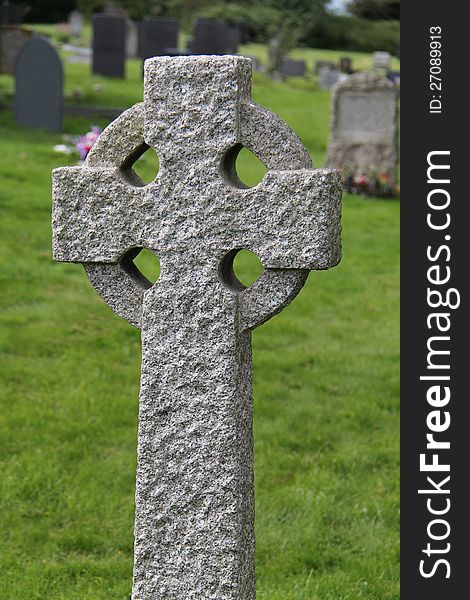 A Celtic Stone Cross Standing in a Graveyard. A Celtic Stone Cross Standing in a Graveyard.