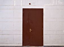 Rusty Metal Door In Beige Block Wall Stock Images