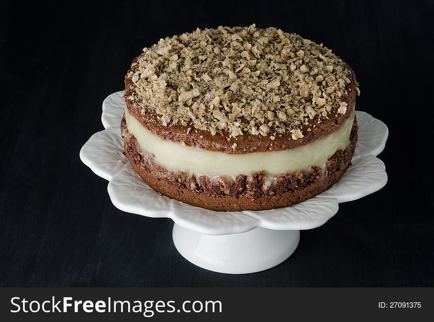 Chocolate cake with pear puree and topping on a black background