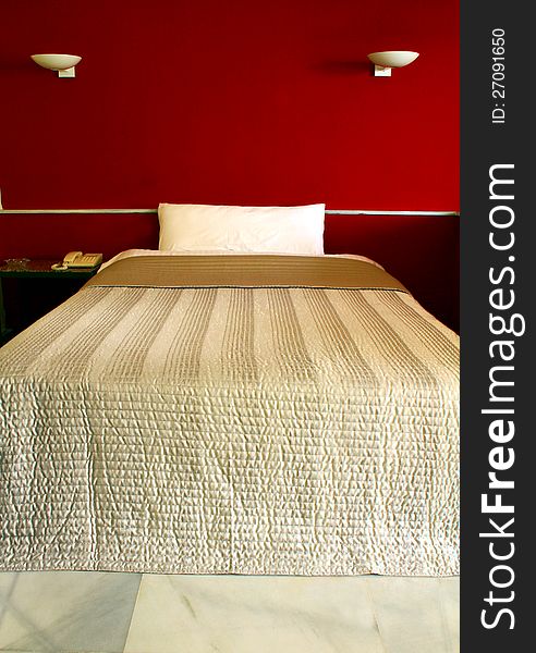 Image of a bedroom hotel with white phone on table. Image of a bedroom hotel with white phone on table