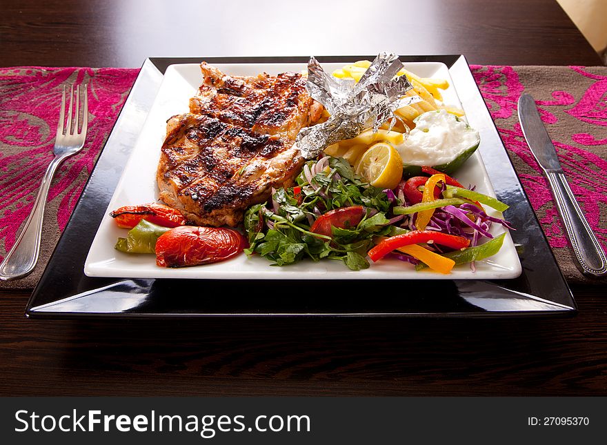 Grilled chicken with chips and vegetables. Grilled chicken with chips and vegetables