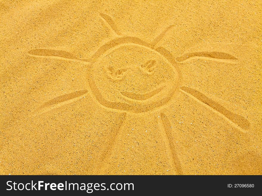 Simple sun drawn on a sandy beach. Simple sun drawn on a sandy beach