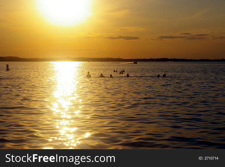 Swimmers at sunset