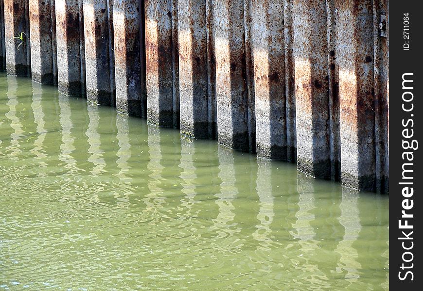 Water level markings on a seawall at a marina