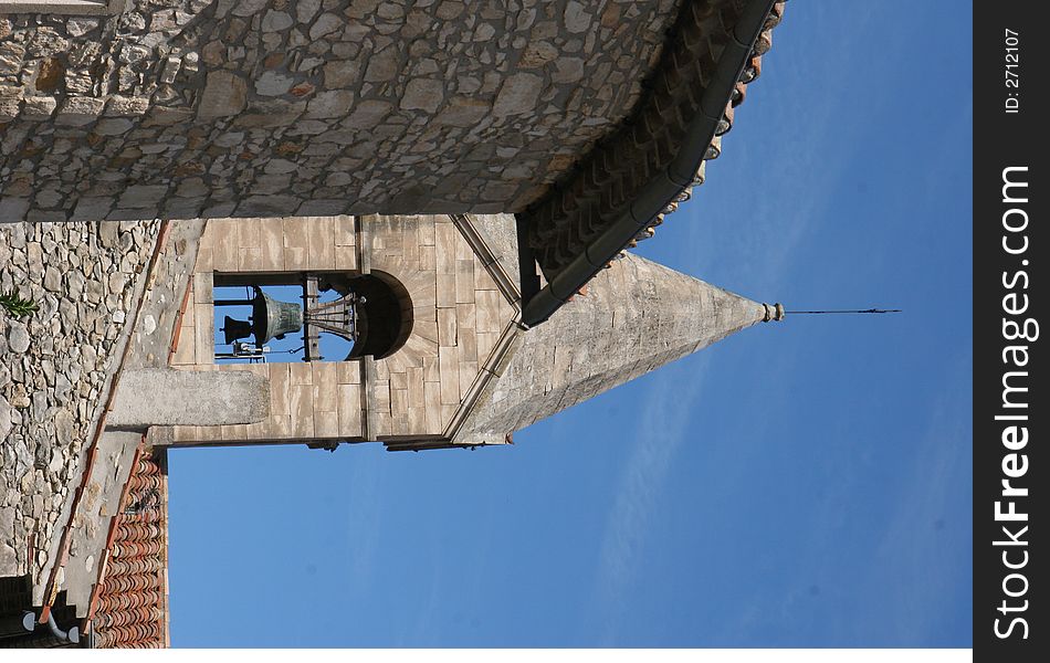 A french church tower with a bell