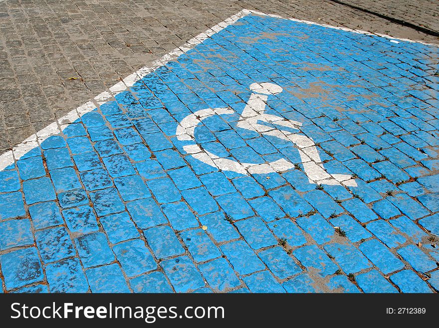 A slot for the handicapped in a car's parking lot. A slot for the handicapped in a car's parking lot