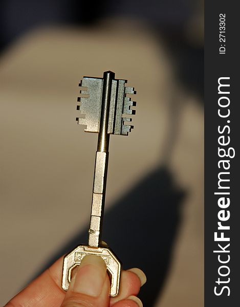 Woman holding a key in the sunlight. Woman holding a key in the sunlight