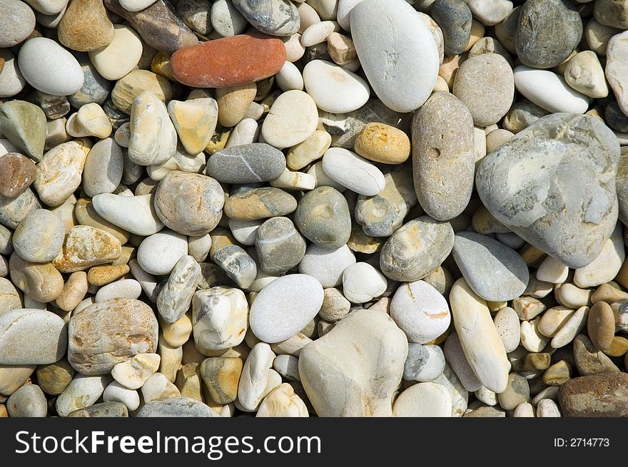 Colorful pebbles background from a mediterranean beach