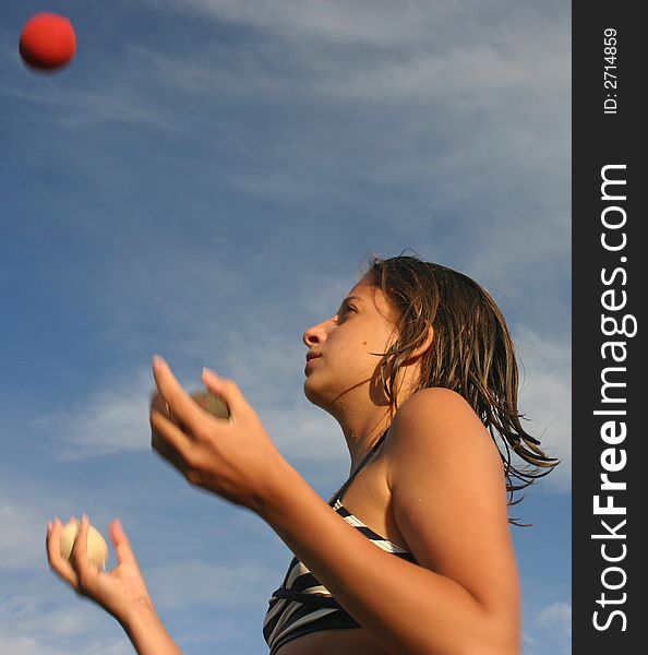Girl in swimsuit juggling with the balls. Girl in swimsuit juggling with the balls