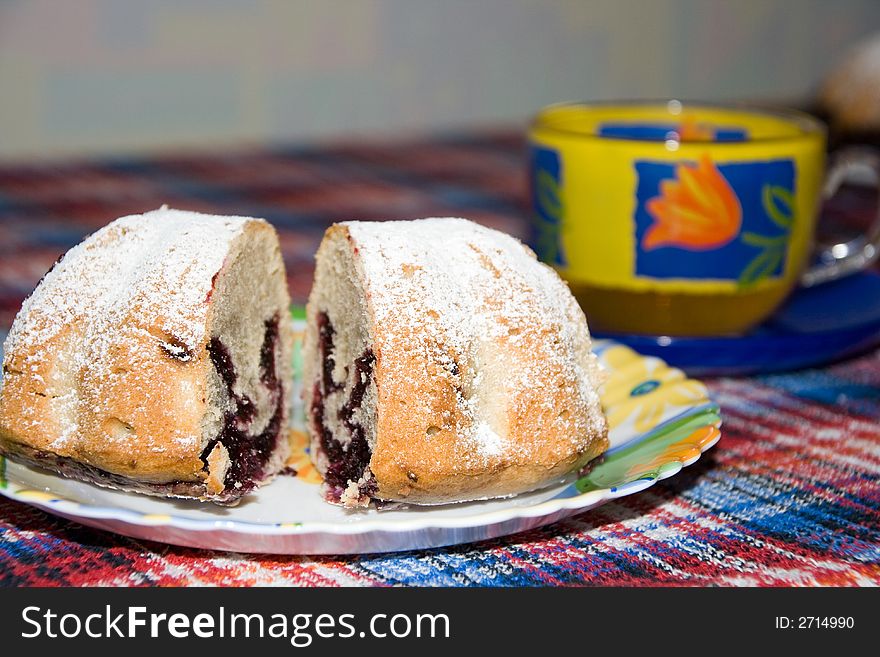 Fruit cake covered with icing sugar and tea