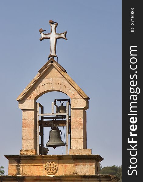 A belltower and a cross in old quarter of Jerusalem. A belltower and a cross in old quarter of Jerusalem