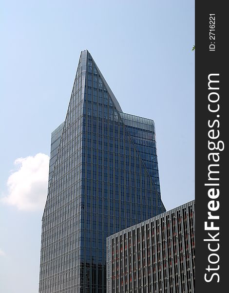 Blue glass office building with pyramid top. Blue glass office building with pyramid top