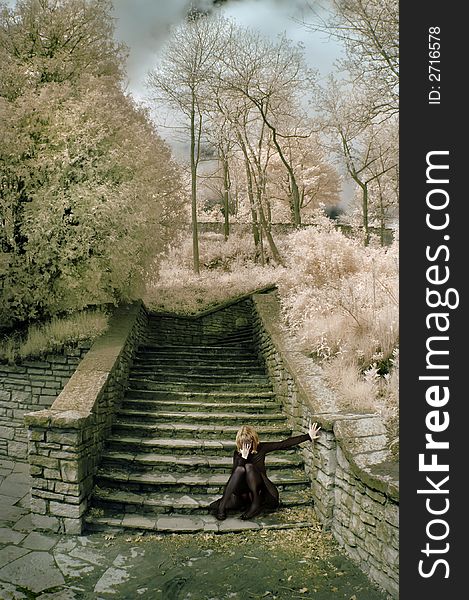 Distressed woman on stone steps in infrared. Distressed woman on stone steps in infrared.
