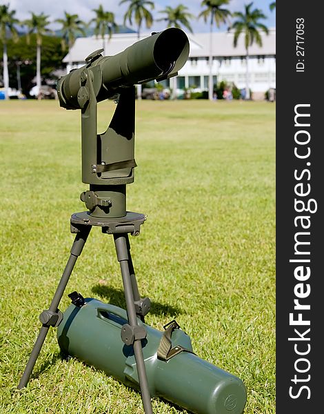 Army spotting scope setup on an open field