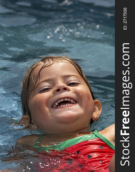 Young girl smiling in pool water. Young girl smiling in pool water