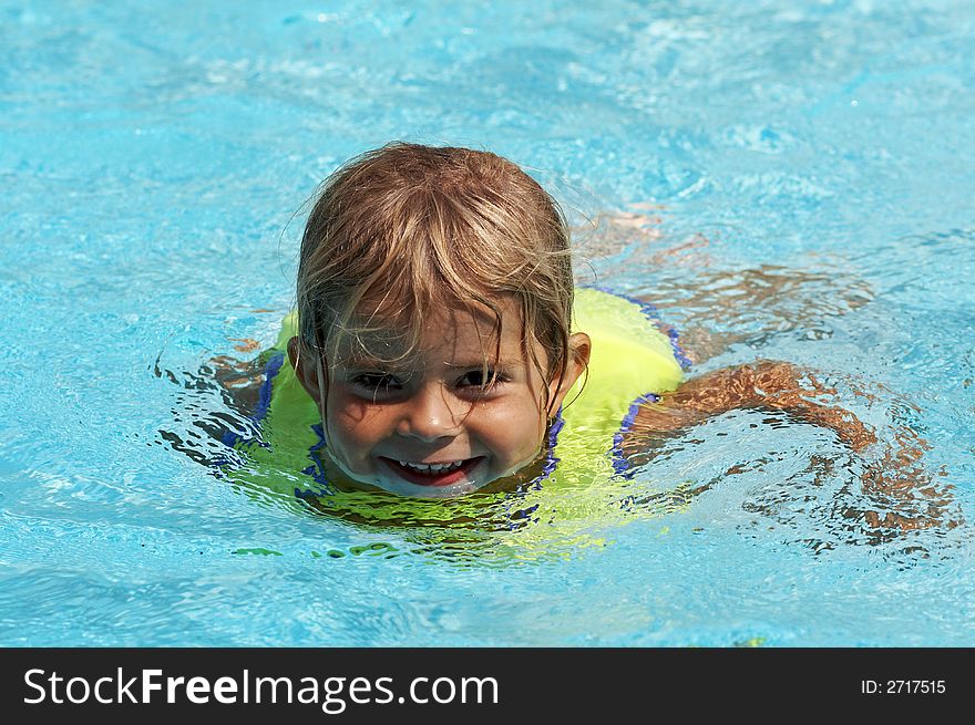 Young girl smiling in pool water. Young girl smiling in pool water